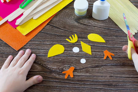 The child cuts out parts giftware. Children's Easter gift toy chicken and Easter bunny. Hand-made. The project of children's creativity, needlework, crafts for children.の写真素材