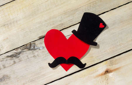 A cheerful father's day background or card with copy space. Black hat, mustache and red heart.の写真素材