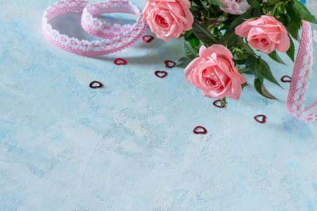 A bouquet of fresh pink rose flowers on a blue backgroundの写真素材