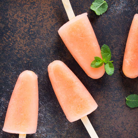 Delicious fruit ice grapefruit and mint on a stone background. Top view with copy space.の写真素材