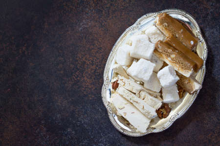 Rahat Lukum, sherbet and halva on the kitchen table. Turkish and Arabic sweets. Ramadan food. Top view. Copy space.の写真素材