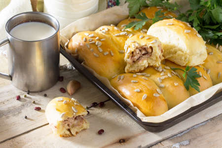 Homemade pies with meat and beans (minced meat and yeast dough) on the kitchen table in a rustic style.の写真素材