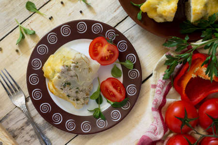 Cauliflower baked with cheese, stuffed with minced meat on a kitchen table in a rustic style. Top view.の写真素材