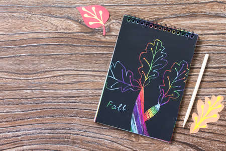 Autumn background. Children's creativity, drawing creation process. Colored different autumn leaves....