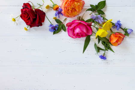 Colorful garden flowers on a white wooden background. Flat lay, top view.の写真素材