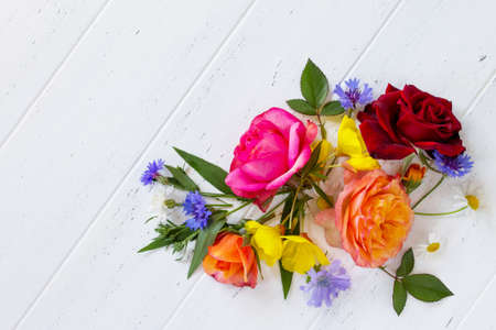 Colorful garden flowers on a white wooden background. Flat lay, top view.の写真素材