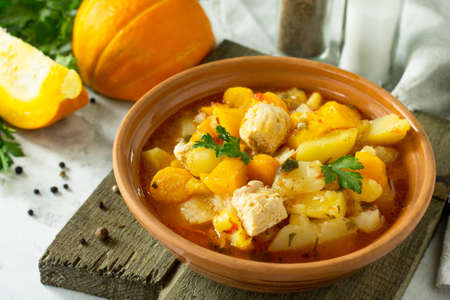 Turkey stew with pumpkin, vegetables and spices in a bowl on a stone background.の写真素材