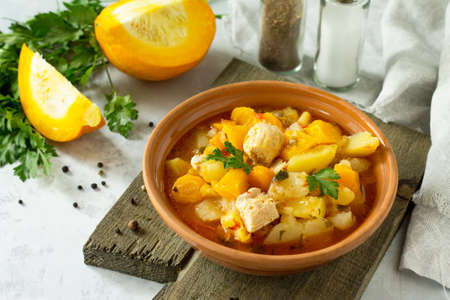 Turkey stew with pumpkin, vegetables and spices in a bowl on a stone background.の写真素材