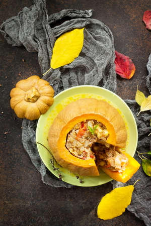 Baked pumpkin stuffed with Turkey, tomatoes, onions and cheese. The concept of food on thanksgiving. Top view with copy space.の写真素材