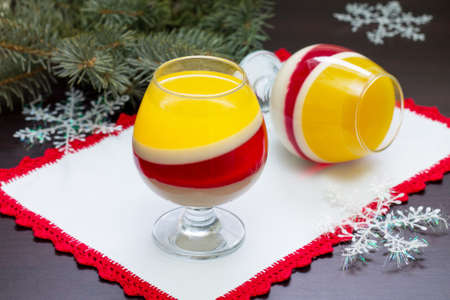 Christmas dessert jelly is a fruit berry raspberry and orange is served in portioned glasses.の写真素材