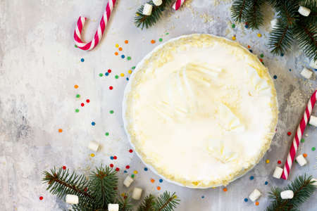 Holiday cake with icing white chocolate on festive christmas background.の写真素材