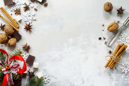 Ingredients for Christmas baking - chocolate, spices, sugar and nuts on stone or slate. Seasonal, food background.の写真素材