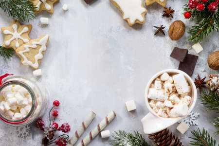 Christmas frame. A cup of hot chocolate and gingerbread, Christmas gifts on the table. Flat lay, top view with copy space.の写真素材