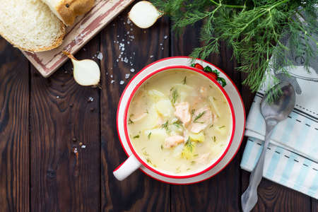 Finnish fish soup with salmon on a kitchen wooden kitchen table, top view.の写真素材