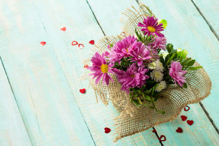 Valentine's Day or greeting card. Beautiful bouquet of flowers as a gift on a vintage wooden...