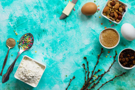 Ingredients for Easter baking - sprinkling confectionery, nuts, eggs, flour, yeast, butter, raisins and sugar on the rock or shale. Seasonal, food background.
の写真素材