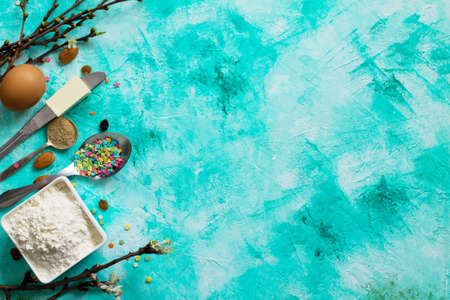 Ingredients for Easter baking - sprinkling confectionery, nuts, eggs, flour, yeast, butter, raisins and sugar on the rock or shale. Flat lay. Top view with copy space.の写真素材