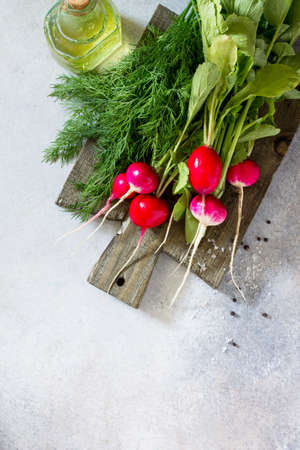 Radish. Red fresh radish, olive oil and fresh herbs on a stone or slate background. The concept of healthy and dietary nutrition. Top view with copy space.
の写真素材