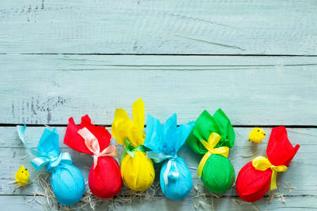 Gift decorative Easter egg handmade tied with ribbons on a wooden table.  Space for your text.