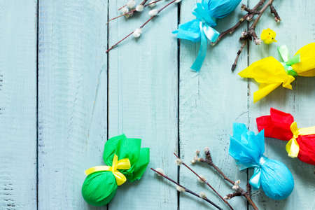 Easter background. Gift decorative Easter egg handmade tied with ribbons on a wooden table.  