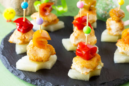 Easter recipe, festive appetizer. Canapes with pineapple, grill chicken, and marinated peppers.