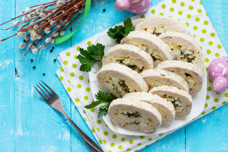 Easter recipe, festive appetizer. Meatloaf with egg, cheese and greens. Copy space, top view flat lay background.の写真素材