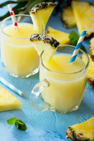 Homemade refreshing fruit beverage with pineapple, vitamin drink diet or vegan food concept. Cold summer drink. Copy space.の写真素材