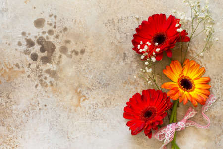 A bouquet of gerbera flower on a stone background or slate with copy space.の写真素材