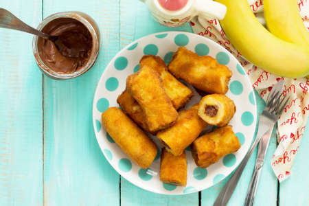 Homemade dessert of fried bananas fried stuffed with chocolate. Copy space, top view flat lay background.の写真素材