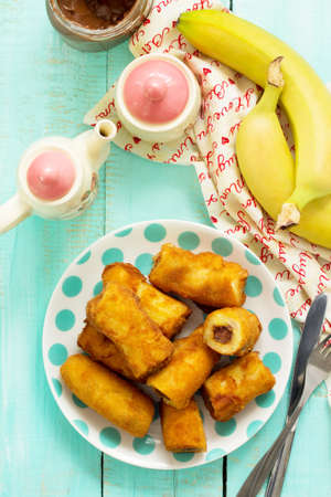Homemade dessert of fried bananas fried stuffed with chocolate. Top view flat lay background.の写真素材