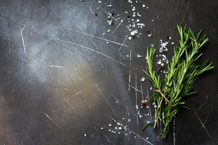 Spices and herbs on a dark stone or slate table. Ingredients for cooking. Food background. Copy space, top view flat lay background.の写真素材
