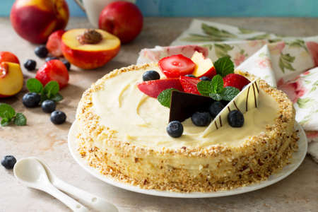 Delicious dessert cake with fresh berries and whipped cream, sweet delicious holiday cake with blueberries and strawberries on stone background.の写真素材