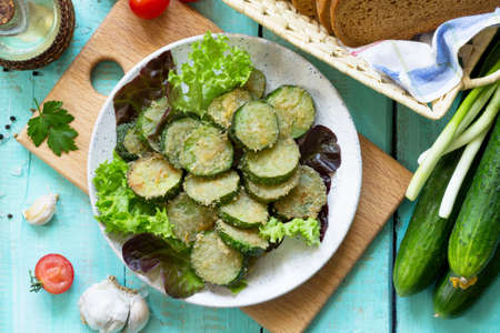 Fried zucchini or cucumber. Fast food on the kitchen table. Top view flat lay background.の写真素材