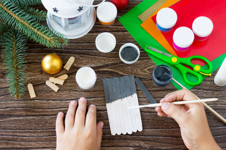 The child draws details Christmas decoration or Christmas gift - Snowman. Handmade. Project of children's creativity, handicrafts, crafts for kids.の写真素材