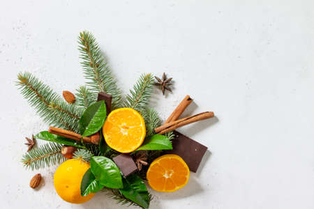 Fresh and Juicy Tangerines, Spruce branches, Snow, and various Christmas Ingredients for Baking on stone or concrete table.の写真素材