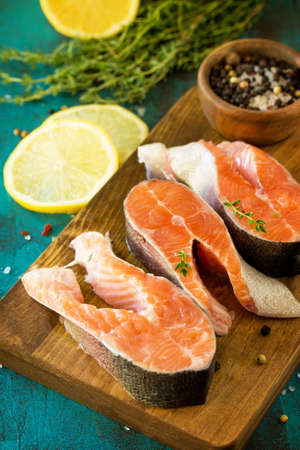 Fresh Fish. Raw Salmon Steak on blue slate table.の写真素材