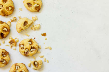 Baked Christmas cookies. Homemade Chip Cookies with Caramel and Salted Peanuts on a light stone...