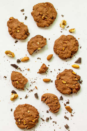 Baked Christmas cookies. Homemade Chocolate Chip Cookies with Nuts on a light stone table. Top view...