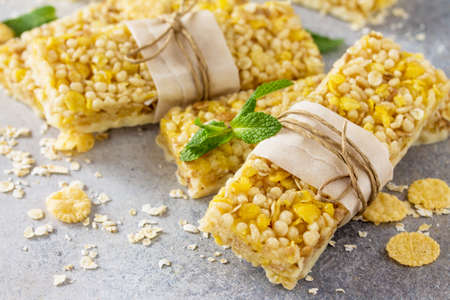 Superfood breakfast. Healthy sweet dessert snack. Multi grain granola muesli bar on stone table. Copy space.の写真素材