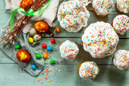 Springtime. Festive composition in rustic style. Easter cake and painted eggs on wooden table. Copy...
