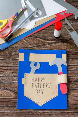 Greeting card with Happy fathers day on wooden table. Children's art project craft for kids. Craft for children.の写真素材