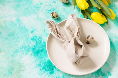 Holidays background. Easter table setting with tulips flowers. Copy space.