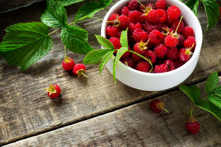 Berry raspberries on a wooden table rustic. Natural detox, fruit dessert, healthy dieting concept....