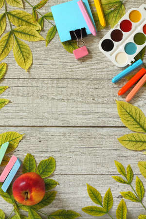 Back to school background. Table with apple, different school supplies, stationery, pencils. Flatlay top view.の写真素材