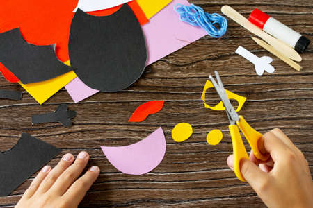 The child cuts out the details of dracula bat for Halloween. Children's art project, craft for children.の写真素材