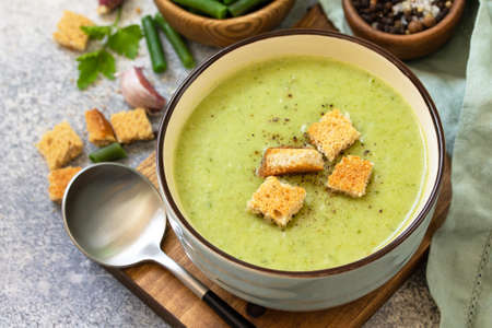 Vegetarian dish. Dietary delicious cream soup of green beans on a light background.の写真素材
