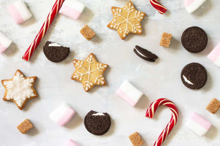 Christmas sweets and gingerbread isolated on a light gray stone background. Top view flat lay...