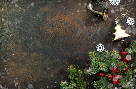 Christmas background frame or greeting xmas card. Christmas tree and decorative ornaments on a dark stone and slate background. Flat lay, top view with copy space.の写真素材