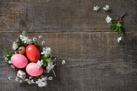 Easter background with  Pink handmade Easter eggs and spring flowers. Top view flat lay background. Copy space.
の写真素材