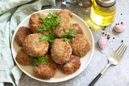 Homemade juicy delicious meat cutlets in plate, meatballs from minced meat on a gray stone table. の写真素材